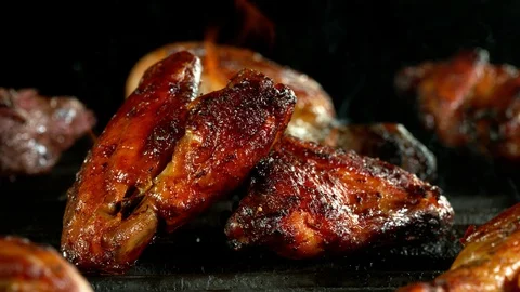 Super slow motion of chicken wings placed on grill. Stock Footage 129841147