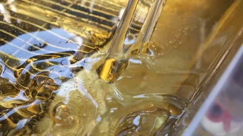Super Slow Motion Close-up of Golden Viscous Liquid Pouring with Bubbles Stock Footage 331955843