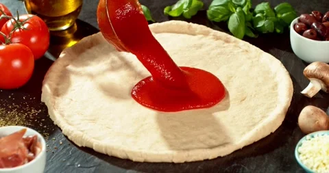 Super slow motion close-up of rich tomato sauce being poured onto pizza dough Stock Footage 328827878