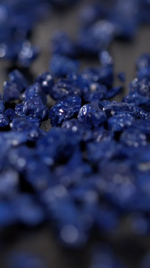 Super slow motion, Closeup Of Blue Pebbles Slowly Moving On Dark Slate With Poli Stock Footage 331721046