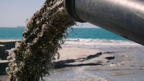 Super slow motion closeup of sand being pumped onto beach to combat erosion. Stock Footage 92339205