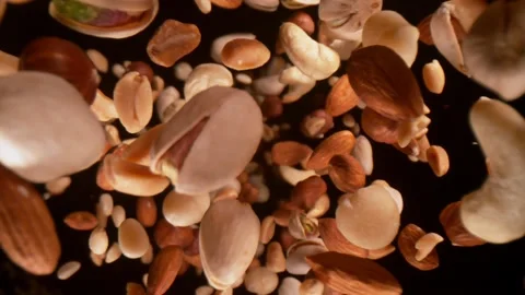 Super Slow Motion Closeup Shot of Falling Various Nuts Towards Camera on Black Stock Footage 170029410