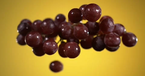 Super slow motion, Clusters Of Grapes Ascend Gently In Slow Motion Over Warm Yel Stock Footage 328962468