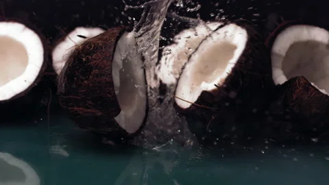 Super slow motion of coconut falling with water splash on green surface. Stock Footage 168296082
