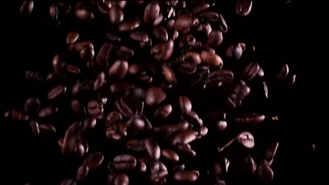 Super slow motion coffee beans falling on a wooden background 1000 fps Stock Footage 130960587