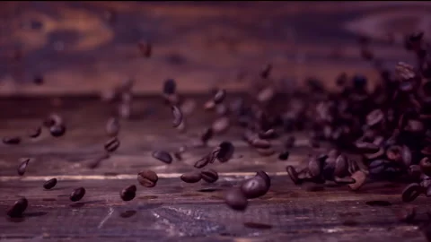 Super slow motion coffee beans falling on a wooden background 1000 fps Stock Footage 130963519