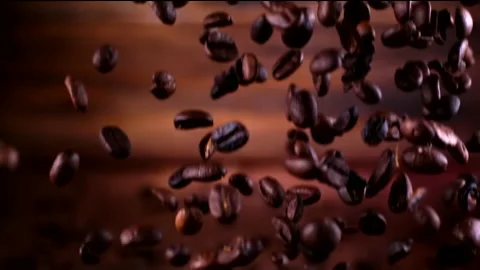 Super slow motion coffee beans falling on a wooden background 1000 fps Stock Footage 130966485