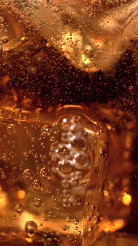 Super slow motion, Cold Cola Closeup Rotating Ice And Bubbles, Amber Liquid Stock Footage 330273517