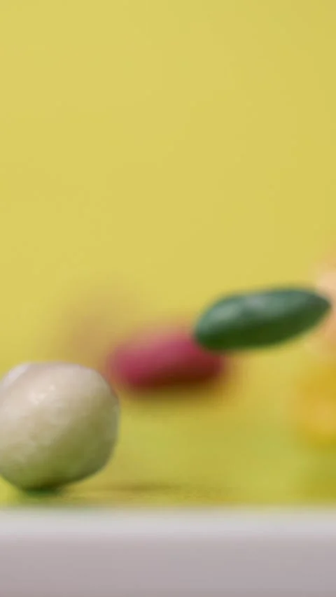 Super Slow Motion Colorful Candy Pieces Bouncing On Yellow  Stock Footage 333485359