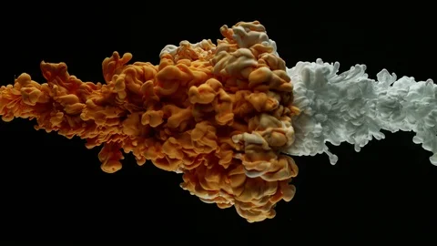 Super slow motion of coloured inks in water. Isolated on black background. Stock Footage 104342849