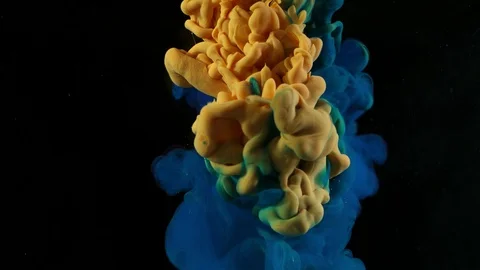 Super slow motion of coloured inks in water. Isolated on black background. Stock Footage 127969207