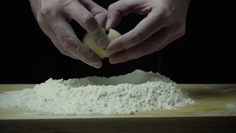 Super slow motion cook breaks egg Stock Footage 72779590