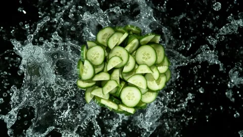 Super slow motion of cucumber slices with water splashes. Stock Footage 231986283
