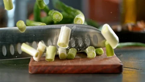Super slow motion of cutting fresh spring onion with kitchen knife. Stock Footage 166960646