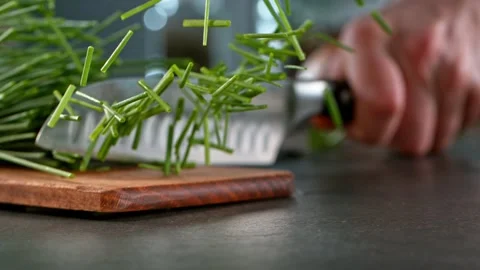 Super slow motion of cutting fresh chive with kitchen knife. Stock Footage 166960859