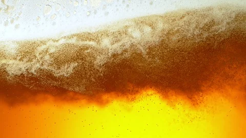 Super Slow Motion Detail Shot of Rippling Beer Bubbles and Foam in Glass at Stock Footage