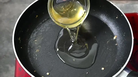 Super Slow Motion Detail Shot of Pouring oil in fry-pen Stock Footage 203477237