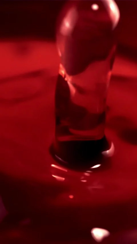Super slow motion drop of wine falls into a glass of splashes. Filmed on a high Stock Footage 335286049