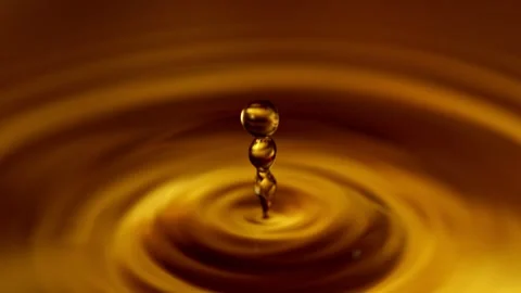 Super Slow Motion of Dropping Dark Golden Coffee or Whiskey Liquid. Stock Footage 279973073