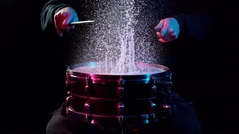 Super slow motion of drummer banging on drum with water splashing Stock Footage 142614694