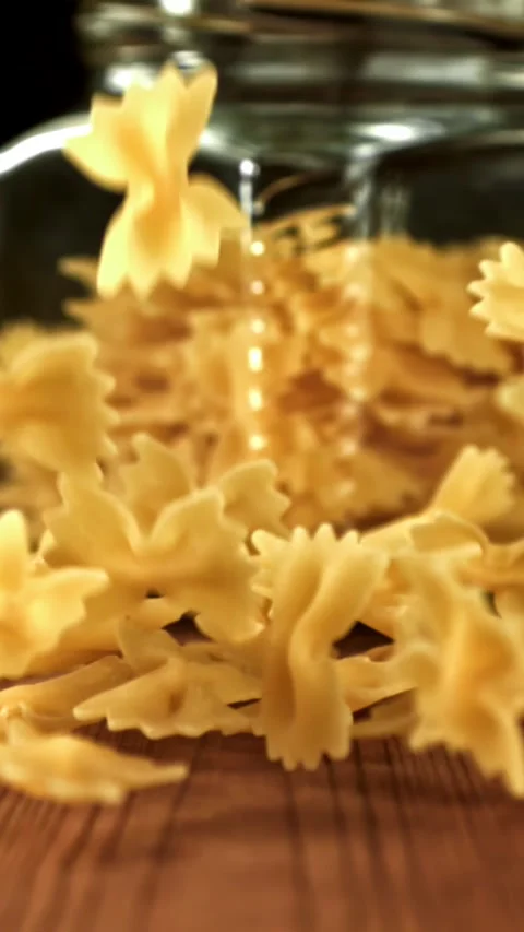 Super slow motion dry farfalle pasta . Filmed on a high-speed camera at 1000 fps Stock Footage 335371960
