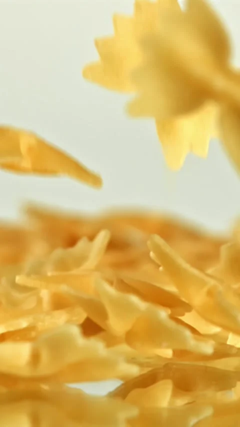 Super slow motion dry farfalle pasta . Filmed on a high-speed camera at 1000 fps Stock Footage 335376608