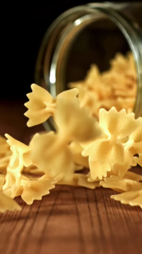 Super slow motion dry farfalle pasta . Filmed on a high-speed camera at 1000 fps Stock Footage 335376795