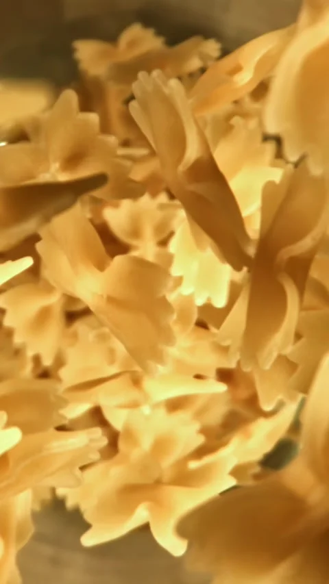 Super slow motion dry farfalle pasta . Filmed on a high-speed camera at 1000 fps Stock Footage 335382561