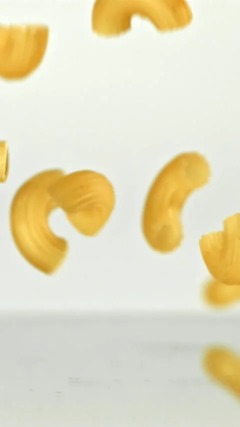 Super slow motion dry macaroni pasta . Filmed on a high-speed camera at 1000 fps Stock Footage 335365317