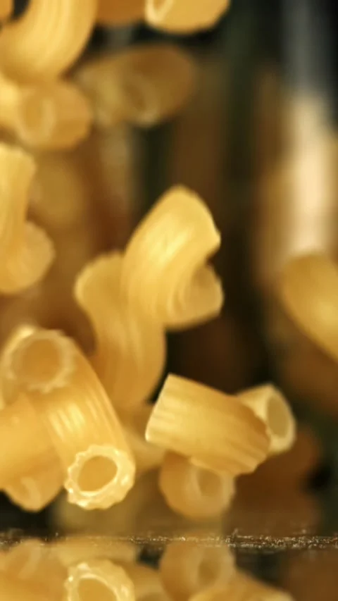 Super slow motion dry macaroni pasta . Filmed on a high-speed camera at 1000 fps Stock Footage 335367636