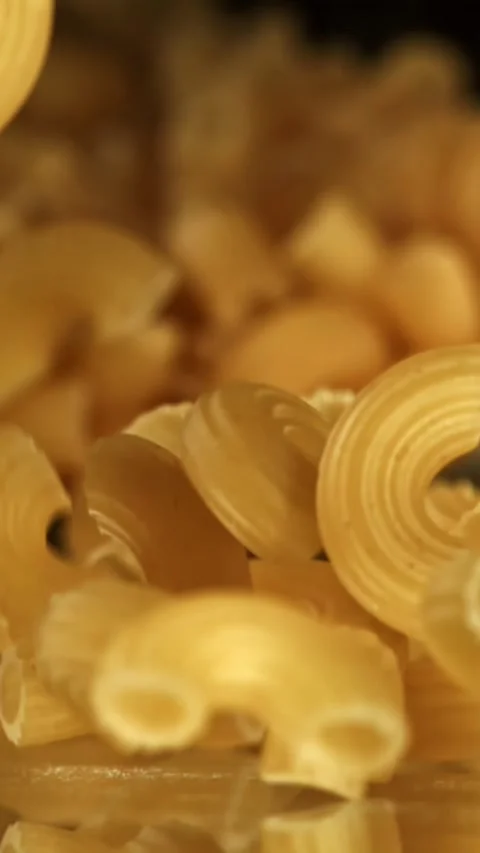 Super slow motion dry macaroni pasta . Filmed on a high-speed camera at 1000 fps Stock Footage 335372112