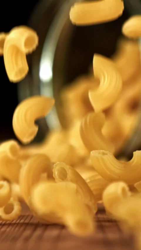Super slow motion dry macaroni pasta . Filmed on a high-speed camera at 1000 fps Stock Footage 335372591
