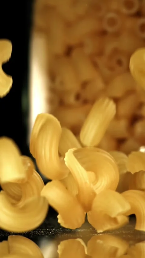 Super slow motion dry macaroni pasta . Filmed on a high-speed camera at 1000 fps Stock Footage 335372635