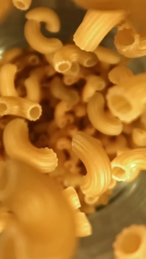 Super slow motion dry macaroni pasta . Filmed on a high-speed camera at 1000 fps Stock Footage 335373924