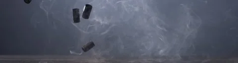 SUPER SLOW MOTION Empty pistol shells falling on a ground against blue bg Stock Footage 152616152