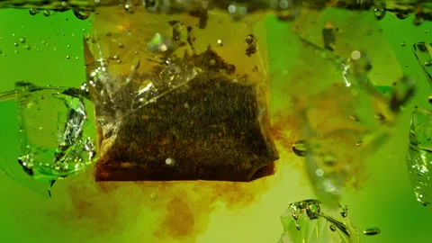 Super Slow Motion of Extracting Tea Bag in Water with Ice at 1000fps, Ice Tea Stock Footage 341830659