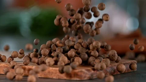 Super slow motion of falling allspice balls on wooden board. Stock Footage 166965749
