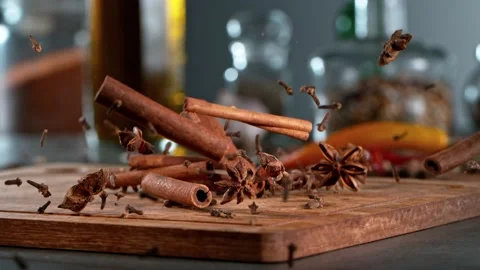 Super slow motion of falling anise, cinnamon and clove on wooden board. Stock Footage 166968507