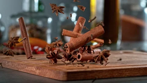 Super slow motion of falling anise, cinnamon and clove on wooden board. Stock Footage 166968909