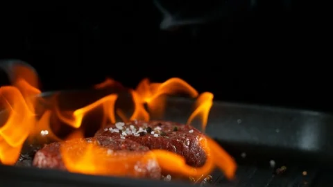 Super slow motion of falling beef minced hamburger meats into flames Stock Footage 98661659