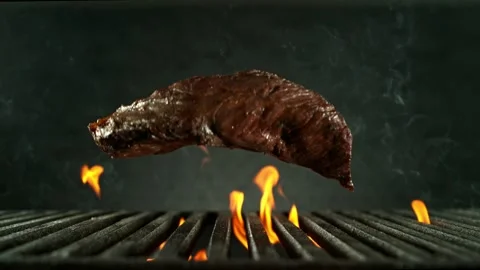 Super Slow Motion of Falling Beef Steak on Grill. Stock Footage 306657852