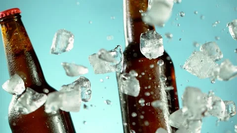 Super slow motion of falling beer bottle into crushed ice pile Stock Footage 157559689