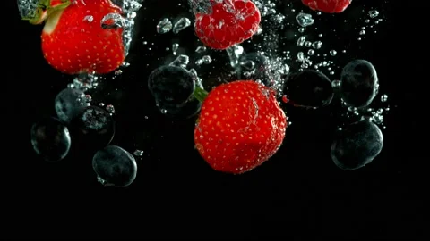 Super slow motion of falling berries underwater. Stock Footage 212016557