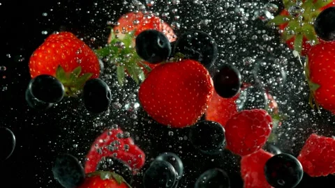 Super slow motion of falling berries underwater. Stock Footage 212016774