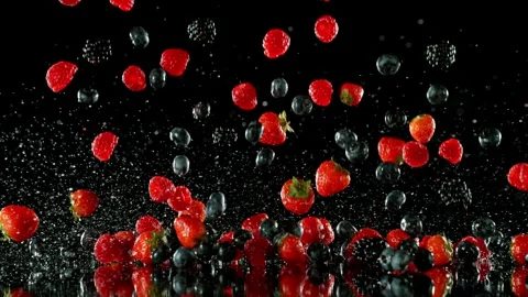 Super Slow Motion of Falling Berries into Water on Black Background. Stock Footage 251311542