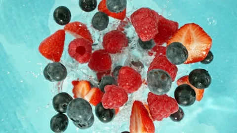 Super Slow Motion of Falling Berries into Water, Blue Background. Stock Footage 275249553