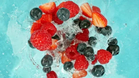 Super Slow Motion of Falling Berries into Water, Blue Background. Stock Footage 275249554