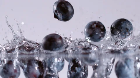 Super slow motion of falling blueberries into water, 1000 fps Stock Footage 90668101