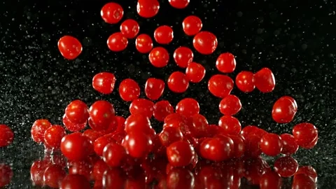 Super Slow Motion of Falling Cherry Tomatoes into Water. Stock Footage 251662055