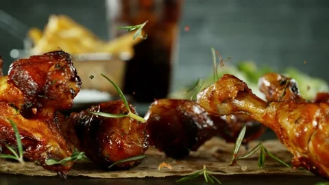 Super slow motion of falling chicken legs and wings on black background Stock Footage 238464349